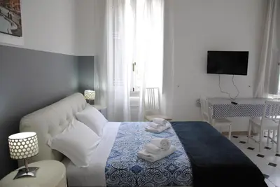 a bedroom with a bed with two towels on it at Vatican Room and Kitchen in Rome