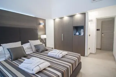 a bedroom with a bed with two pillows on it at Wellness Home Rome in Rome