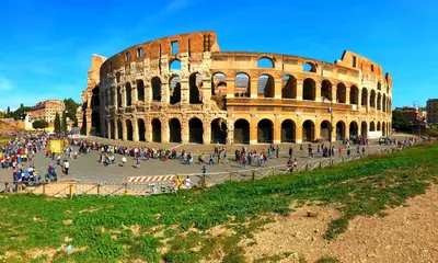 a group of people walking around the coliseum at CASA ARIEL in Rome