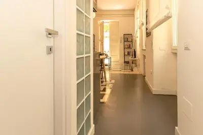 a hallway with glass panels on the wall at Virgiliano Apartment in Rome