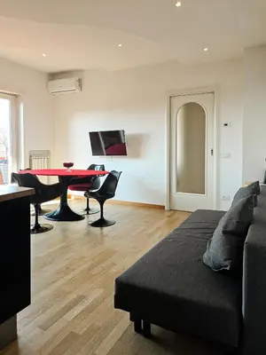 a living room with a red table and chairs at Panoramic Sunset Terrace Attic in Rome