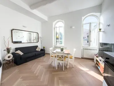 a living room with a black couch and a table at COLOSSEUM STREET HoMe in Rome
