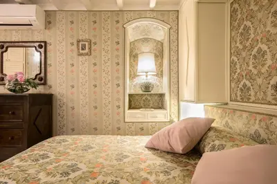 a living room with a television and a table with chairs at Panoramic Trevi Fountain View Luxury Apt in Rome