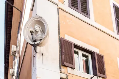 a group of people walking and riding bikes down a street at Panoramic Trevi Fountain View Luxury Apt in Rome