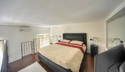 a bedroom with a bed and a flat screen tv at ROME LUXURY HOUSE - THE SUITE in Rome