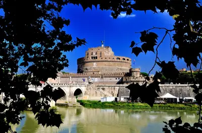 a building next to a river with a bridge at ROME LUXURY HOUSE - THE SUITE in Rome