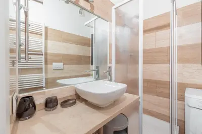 a bathroom with a white sink and a shower at Roman Forum Cozy Apartment in Rome