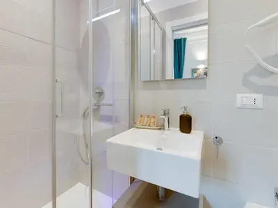 a white bathroom with a sink and a shower at The Right Place - Guest House in Rome
