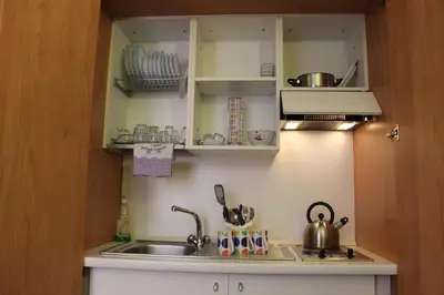 a small kitchen with a sink and a sink at Aida Trevi Fountain Rome in Rome