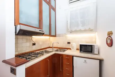 a small kitchen with a sink and a microwave at Campo de' Fiori Cozy Nest in Rome