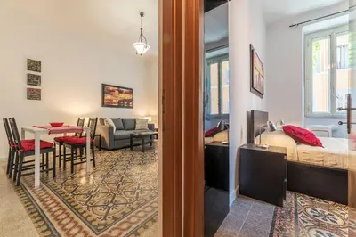 a room with a bed and a dining room at GuestHost - Borgo Pio Elegant Apartment! in Rome