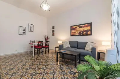 a living room with a couch and a table at GuestHost - Borgo Pio Elegant Apartment! in Rome