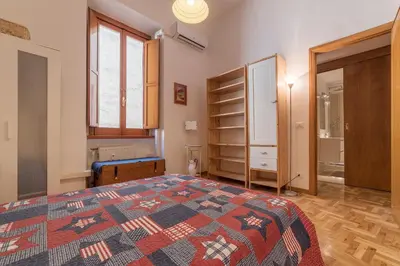 a bedroom with a bed and a room with shelves at GuestHost - Lovely Loft Trastevere in Rome