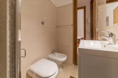 a bathroom with a white toilet and a sink at GuestHost - Lovely Loft Trastevere in Rome
