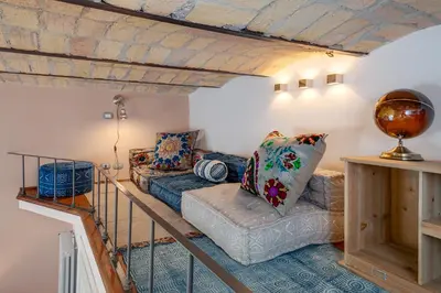 a living room with a couch and a table at One & Only Buonarroti Suite in Rome