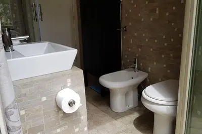 a bathroom with a sink and a toilet and a tub at A casa di Juno 