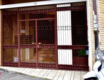 a large metal gate with two dogs in it at Domus Claudia in Rome
