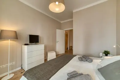 a bedroom with a white bed and a tv at Domus Claudia in Rome