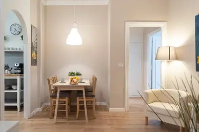 a kitchen and dining room with a table and chairs at Domus Claudia in Rome