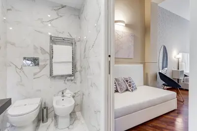 a white bathroom with a toilet and a sink at Trevi Private Suites by Premium Suites Collection in Rome