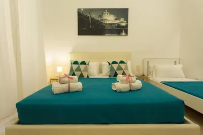 a bedroom with two beds with towels on a blue bed at San Peter Dill House in Rome