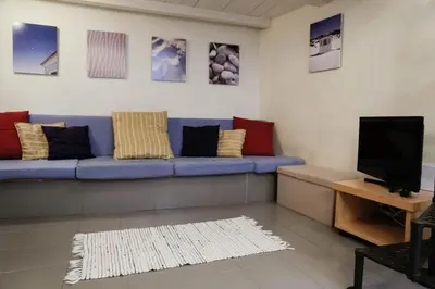 a living room with a blue couch with colorful pillows at Domus Titiana Amazing Apartment in Trastevere in Rome