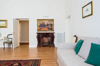a living room with a white couch and a fireplace at SWEET DREAM CAVOUR in Rome
