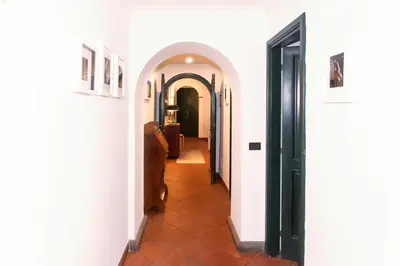 a hallway with white walls and a tile floor at spacious apartment in the centre of Rome in Rome