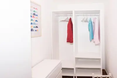 a white walk in closet with a glass door at spacious apartment in the centre of Rome in Rome