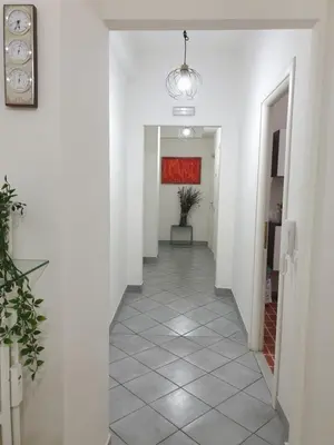 a living room with white walls and a table at Holiday Max in Rome