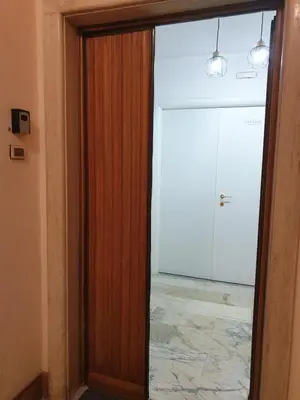 a room with three beds with red curtains and a mirror at Holiday Max in Rome