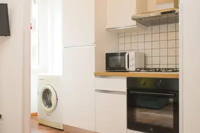 a kitchen with a microwave oven and a stove at St.Peter flat in Rome