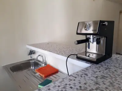 a coffee machine sitting on a counter next to a sink at AFFITTACAMERE ROMANSTYLE in Rome