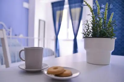 two plates of donuts and a cup of coffee on a table at Vatican Mirò Holidays in Rome