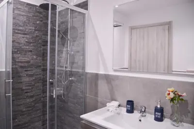 a bathroom with a sink and a shower at Vatican Mirò Holidays in Rome