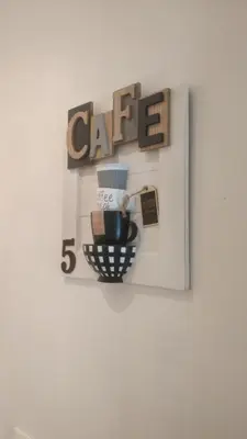 a shelf with a coffee sign on a wall at Pretty Tiburtina Room in Rome