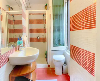 a bathroom with a sink and a toilet at Luxury barberini boutique Apartment in Rome