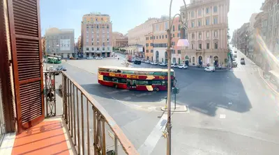 a double decker bus driving down a city street at Luxury barberini boutique Apartment in Rome