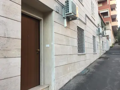 a door on the side of a building next to a street at Il Faro Gianicolense in Rome