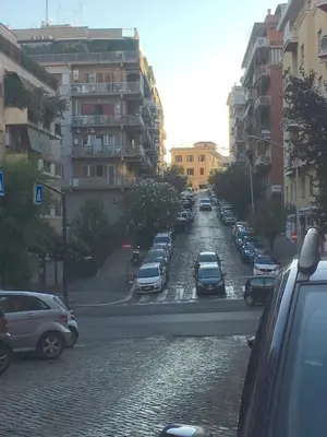 a city street filled with parked cars and buildings at Il Faro Gianicolense in Rome