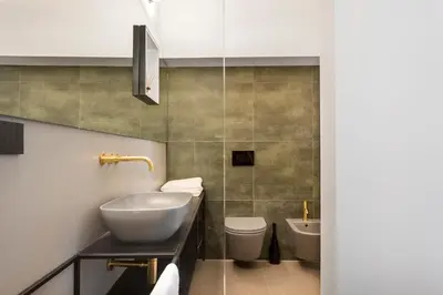 a bathroom with a sink and a toilet and a tub at Monti Exclusive Medieval Tower in Rome