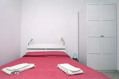 a bedroom with a bed with two white towels on it at Il Cortiletto di Via Tuscolana in Rome