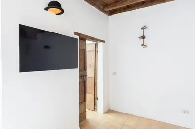 a living room with a large flat screen tv on a wall at A World Aparts - 13 T.Argentina in Rome