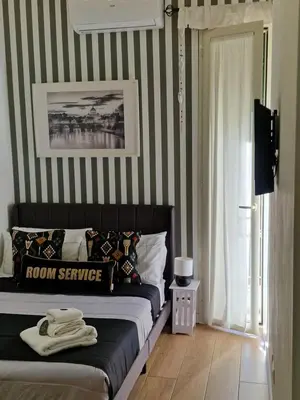 a bedroom with two beds with green sheets at Homey in Rome