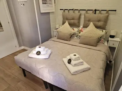 a bed with two towels on top of it at Homey in Rome