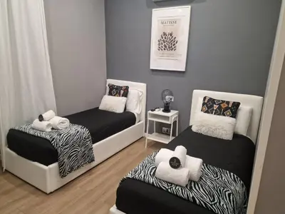 a bedroom with a bed with two towels on it at Homey in Rome