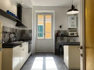 a kitchen with white cabinets and a window at GLAM 50 - Exlusive Penthouse in the Heart of Rome in Rome