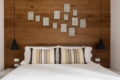 a bed with two pillows and a wooden headboard at Louly Trevi Fountain in Rome
