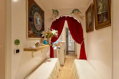 a hallway with a red curtain and two benches at Etere in Prati Rooms in Rome