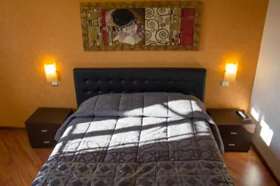 a bedroom with a bed and two night stands with lamps at Affittacamere Mazzini in Rome